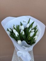 Hand-tied bouquet of 19 fresh white tulips with green stems wrapped in white paper, displayed against a neutral background