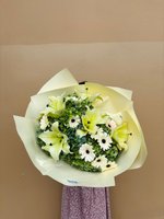 Bouquet with lilies, roses, and orchids in shades of pink, white, and purple.