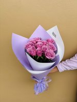 Rachel bouquet featuring thirteen fresh pink roses with green foliage, elegantly wrapped in purple and white decorative paper with a matching ribbo...