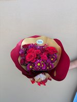 Julie bouquet featuring seven red roses and twelve purple chrysanthemums with yellow centers, wrapped in burgundy and gold paper with matching ribb...