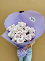 Lavender rose bouquet wrapped in purple paper with a bow