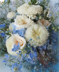 Ocean Mist bouquet with white lychee roses, chrysanthemums, blue hydrangeas, and delphiniums, a calming floral arrangement available in Phuket.