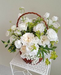 Serene Grace bouquet featuring white roses, lisianthuses, peonies, and greenery in a basket, perfect for elegant occasions in Phuket.